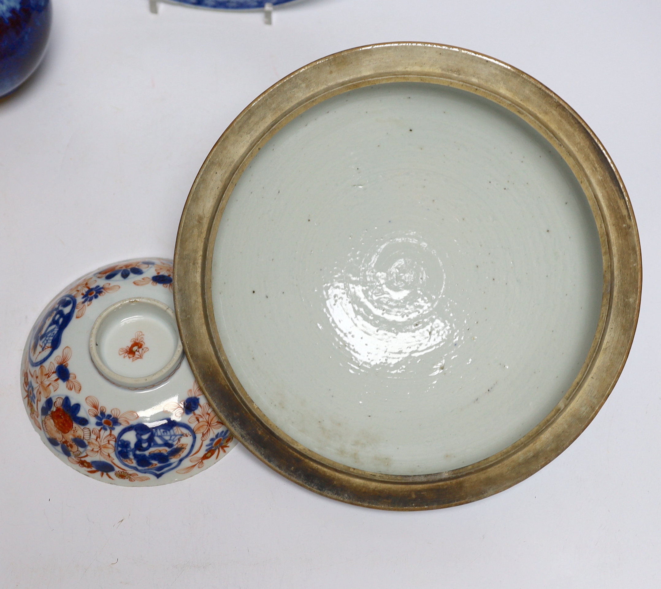 A group of Chinese ceramics including a flambé vase, an 18th century blue and white floral plate and a similar lid, 25cm diameter